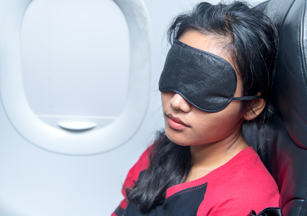 image of a woman sleeping in airplane