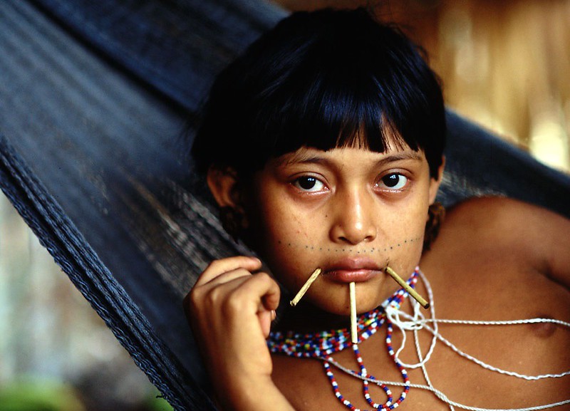 Portrait Photo of Yanomami Girl in hammock facing the camera