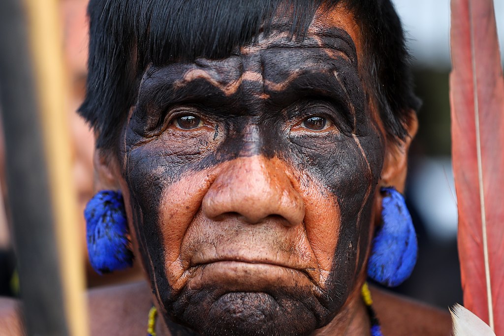 Portrait Photo of Yanomami man with traditionally painted face