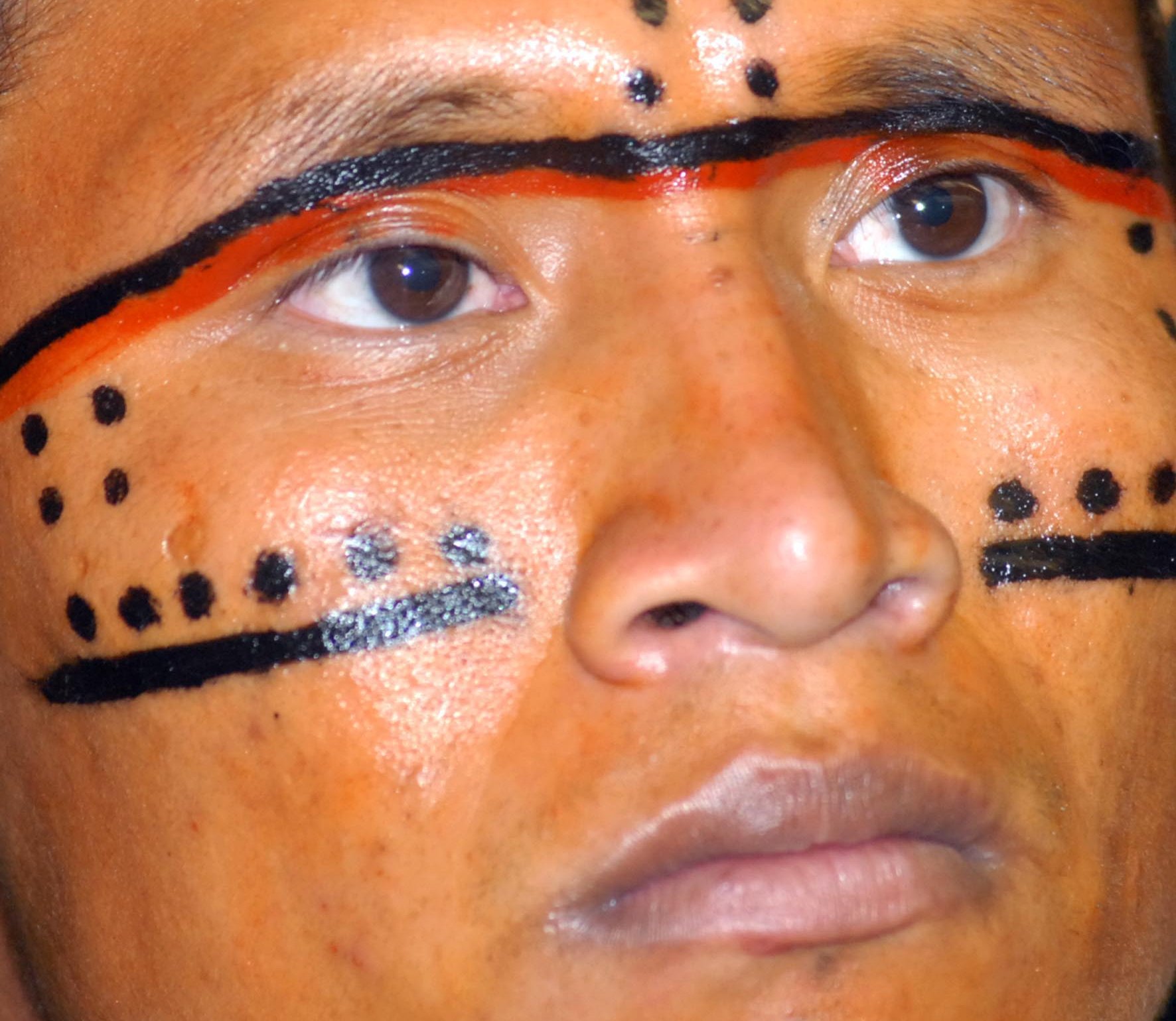Portrait Photo of Yanomami man with Traditional face painting