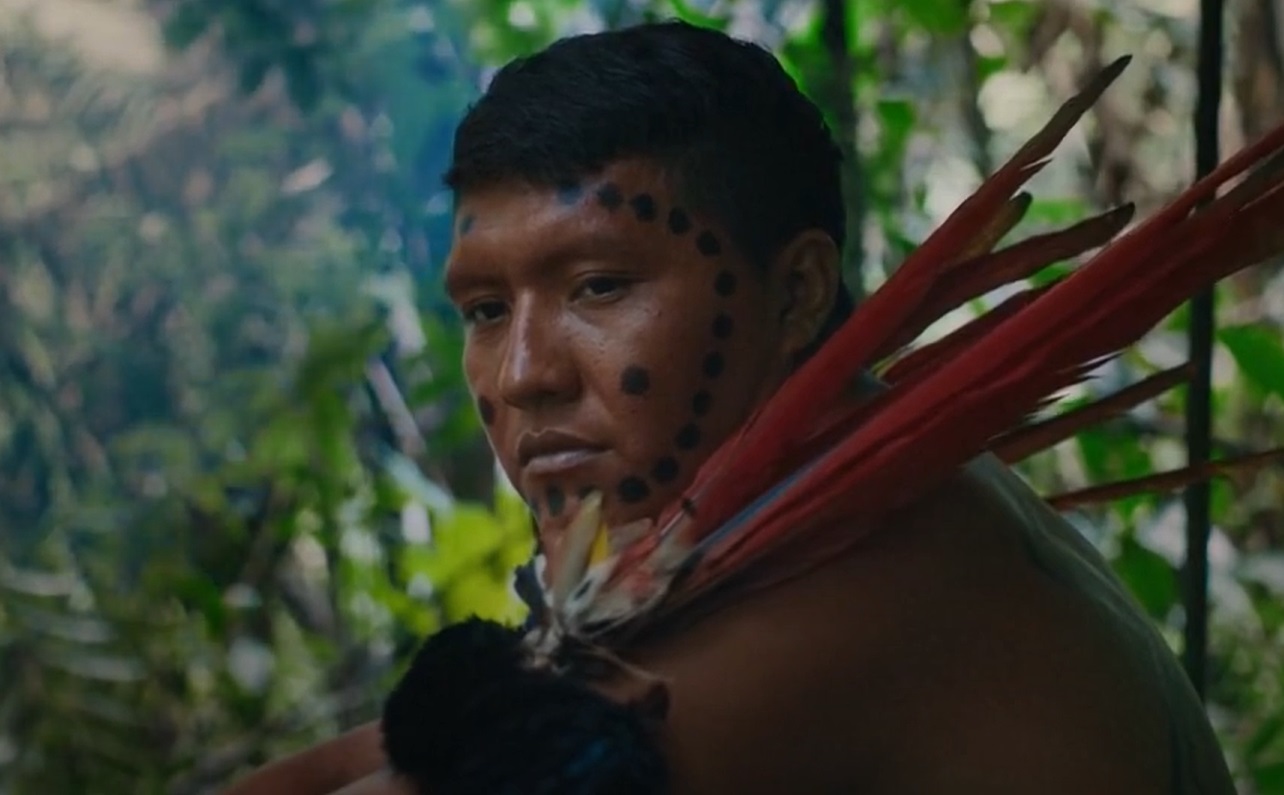 Portrait photo of Yanomami with traditional face painting and body decoration