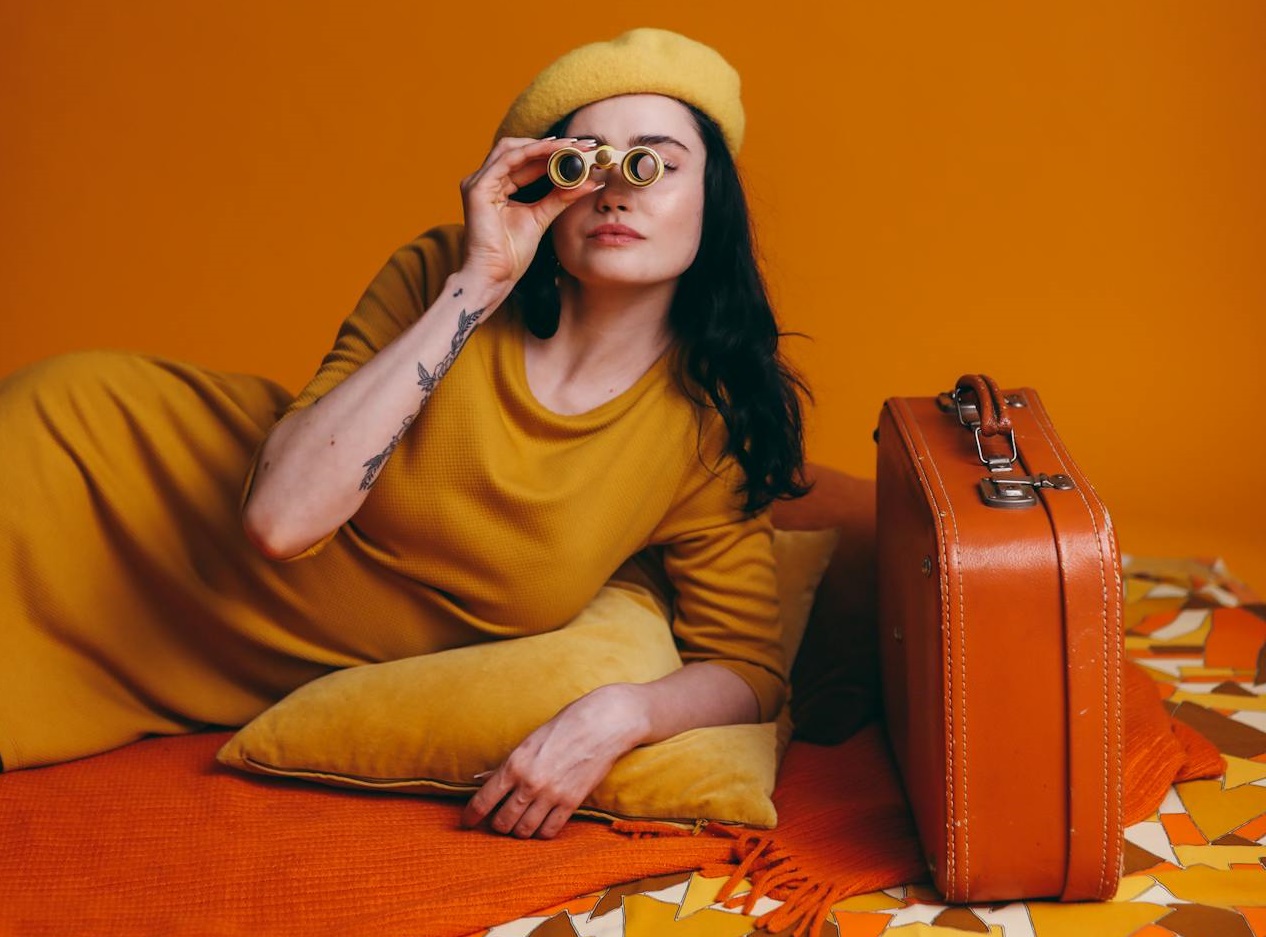 Woman In Yellow Outfit Holding A Yellow Binoculars