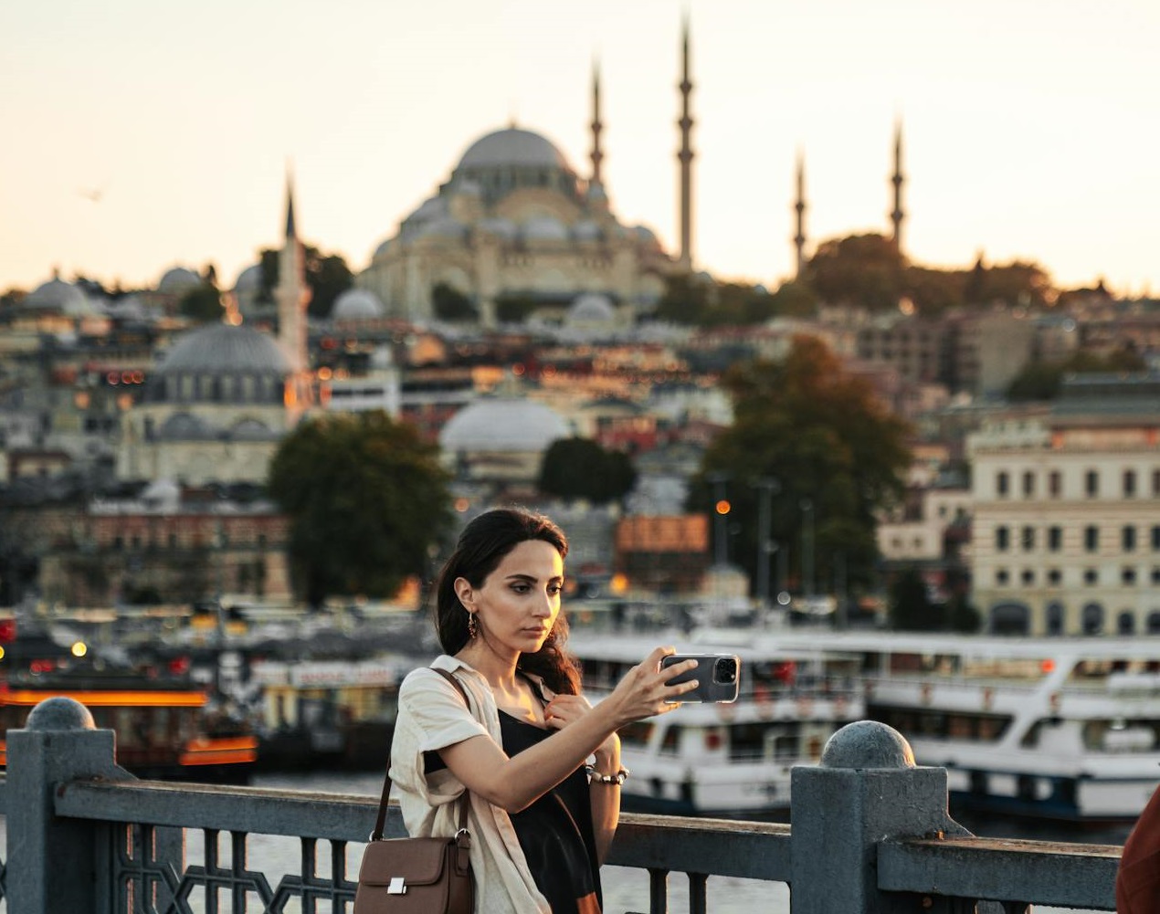 Beautiful Brunette Woman Taking Photo on Bridge in Istanbul