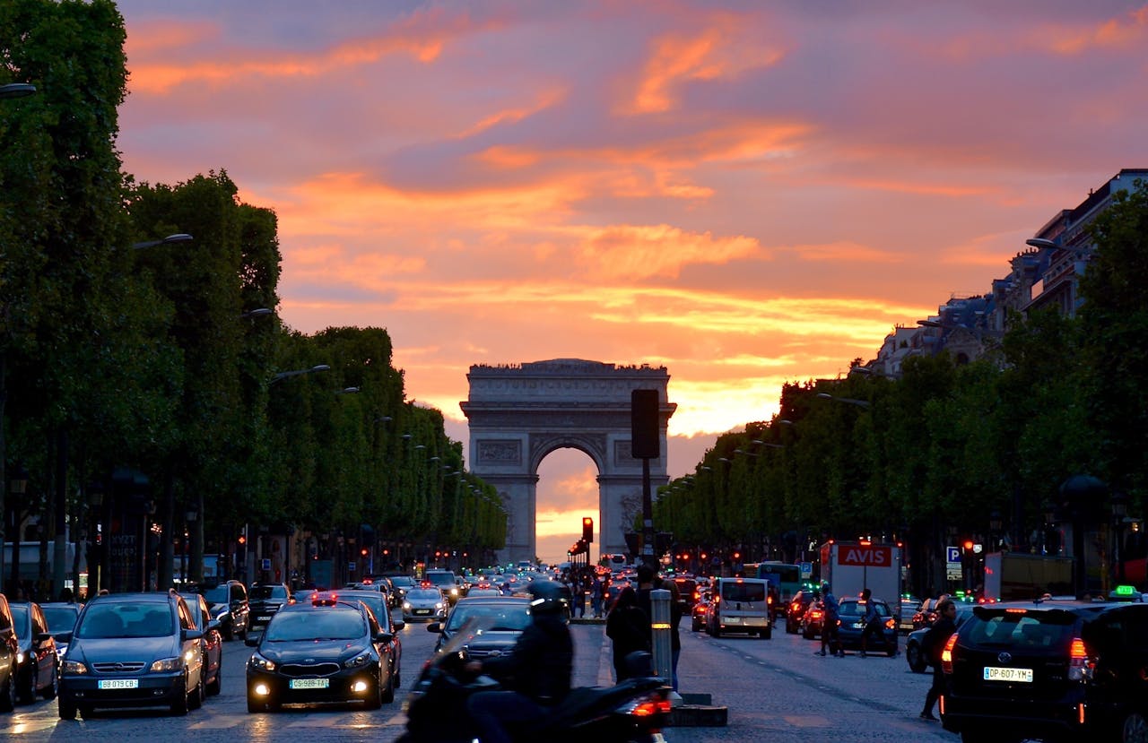Crowded Street With Cars Along Arc De Triomphe in France.