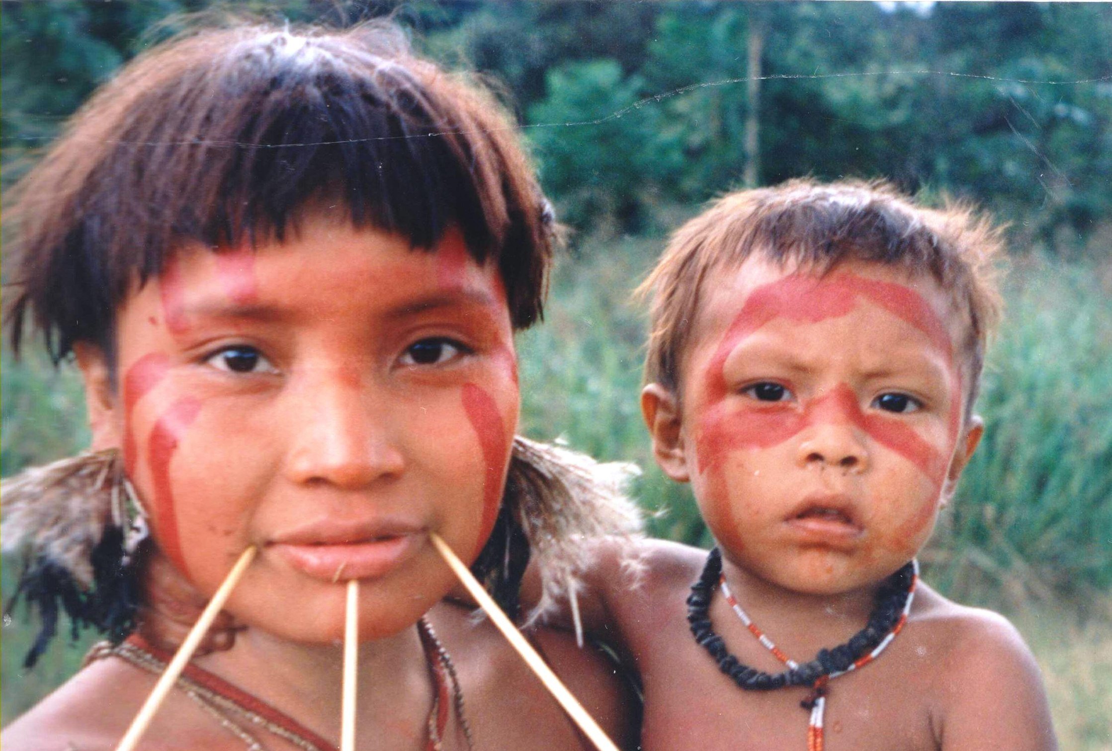 Portrait Photo of Yanomami woman and her child facing the camera