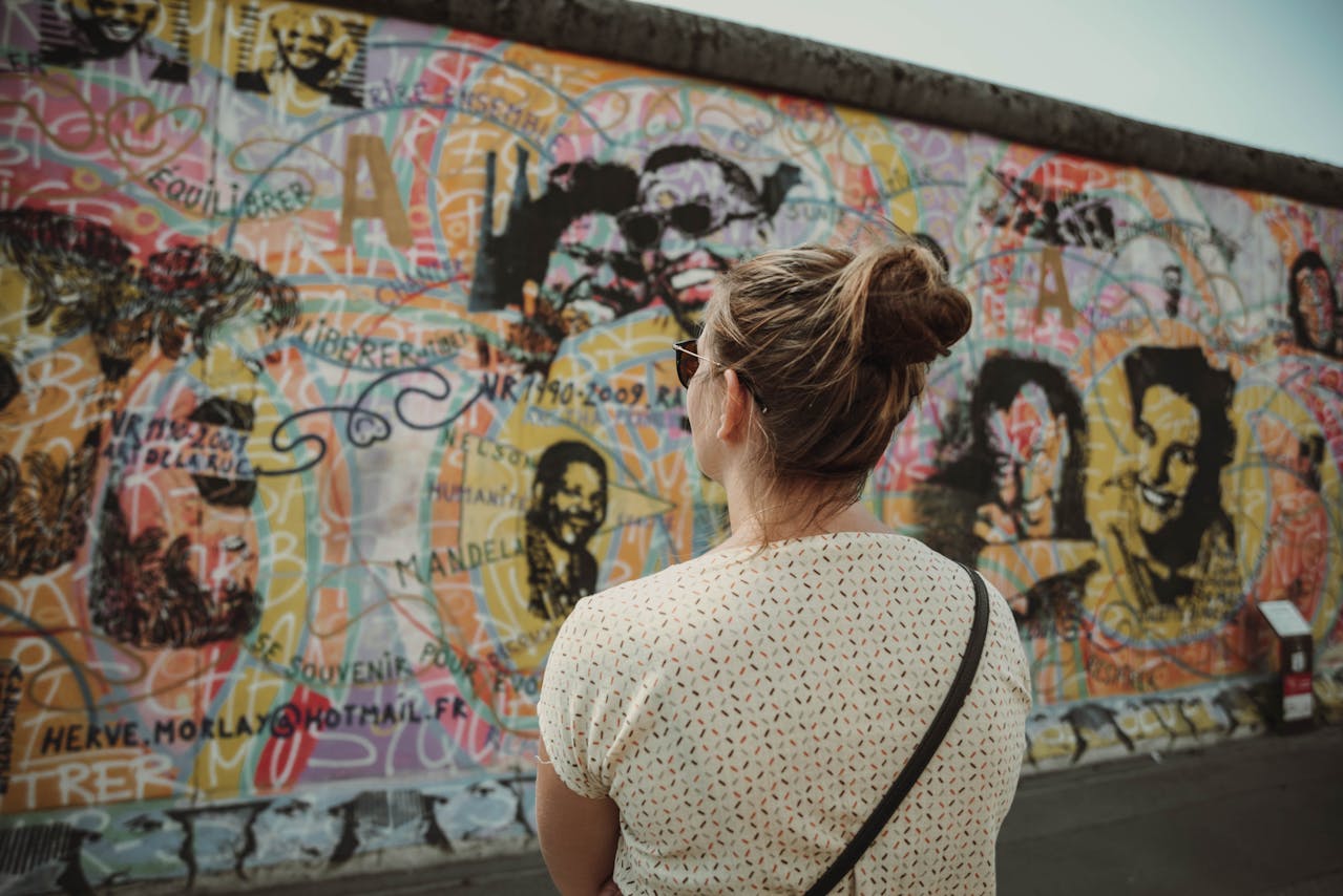 woman looking at a Berlin Wall