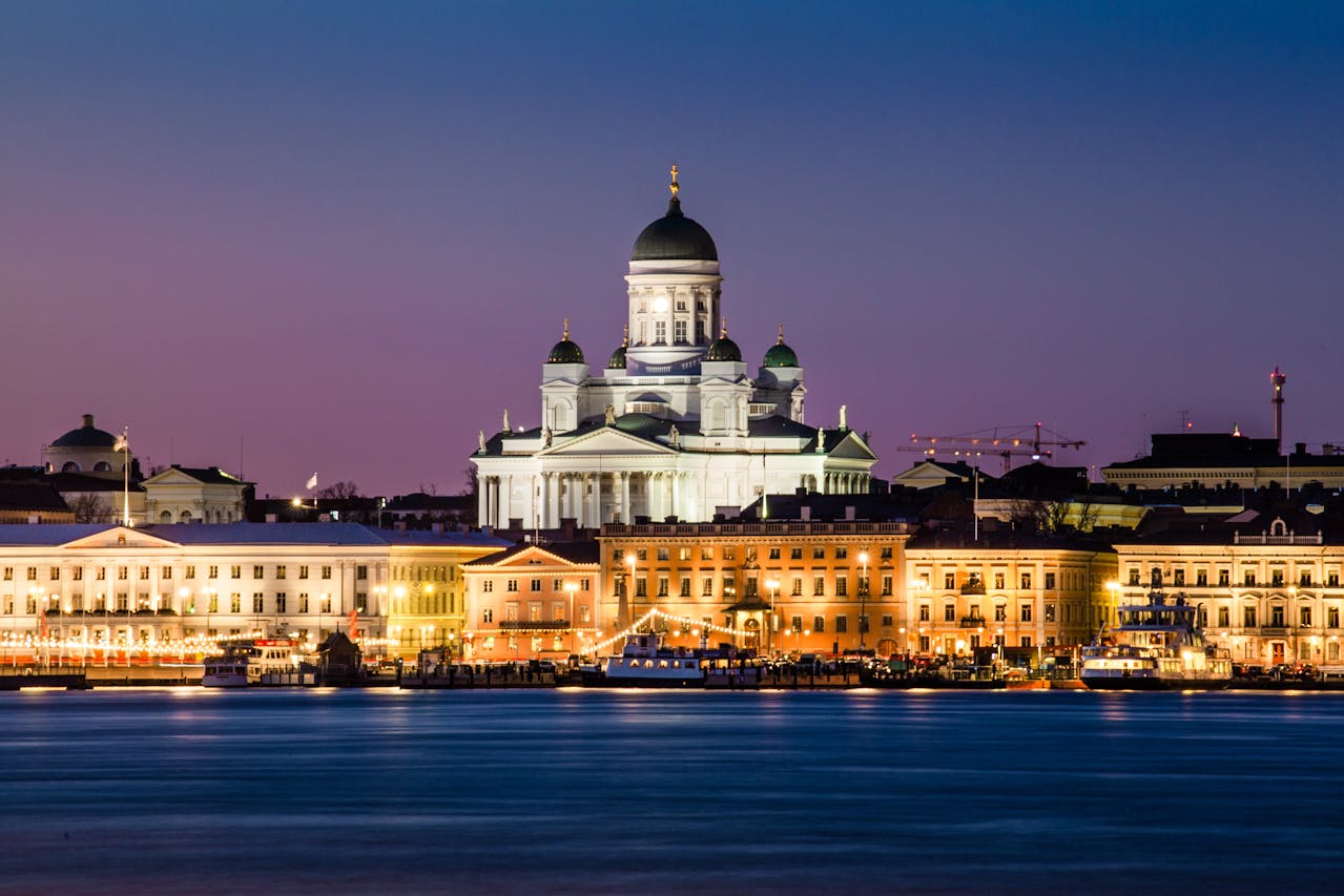 Photo of Cathedral Near Buildings and River in Helsinki