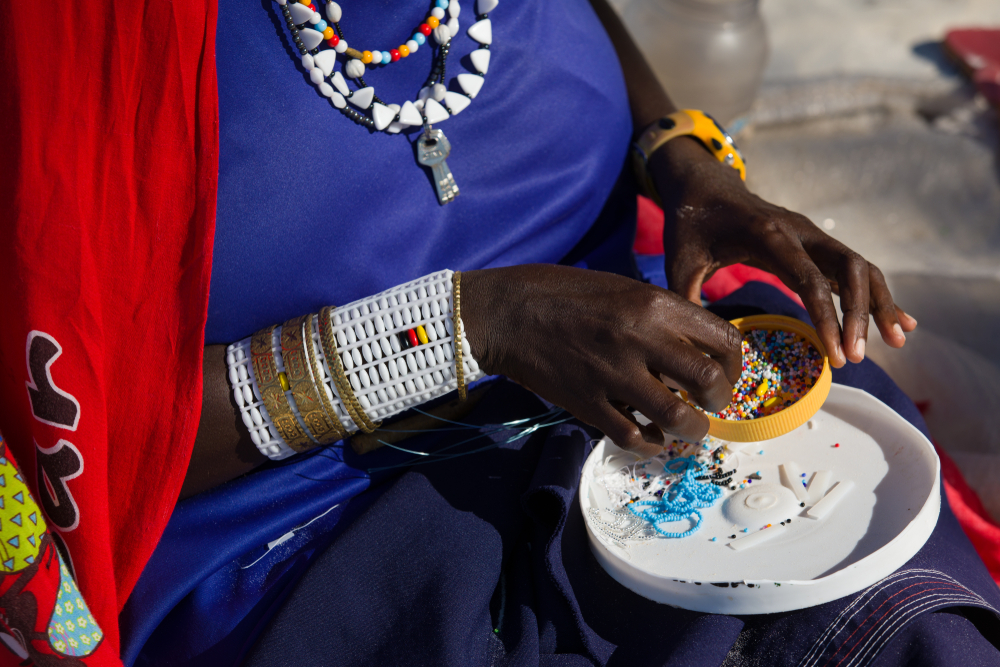 Maasai woman making jewelry