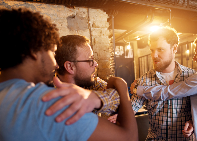 Friends preventing fighting