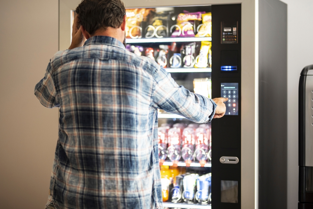 image of a man buying stuff from vending machine