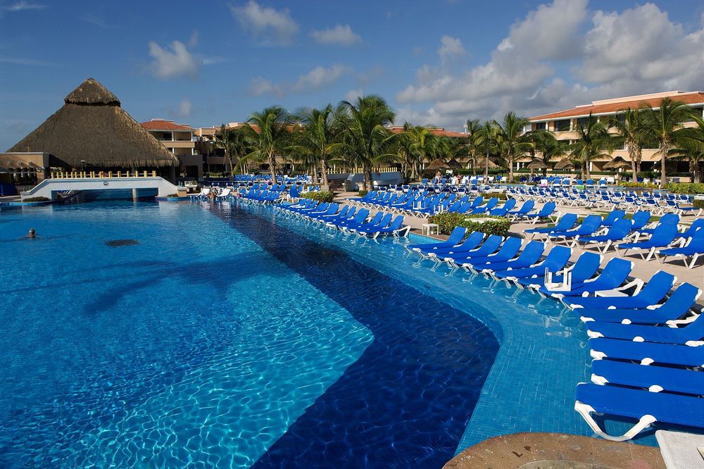Recliners by the side of a pool at a resort