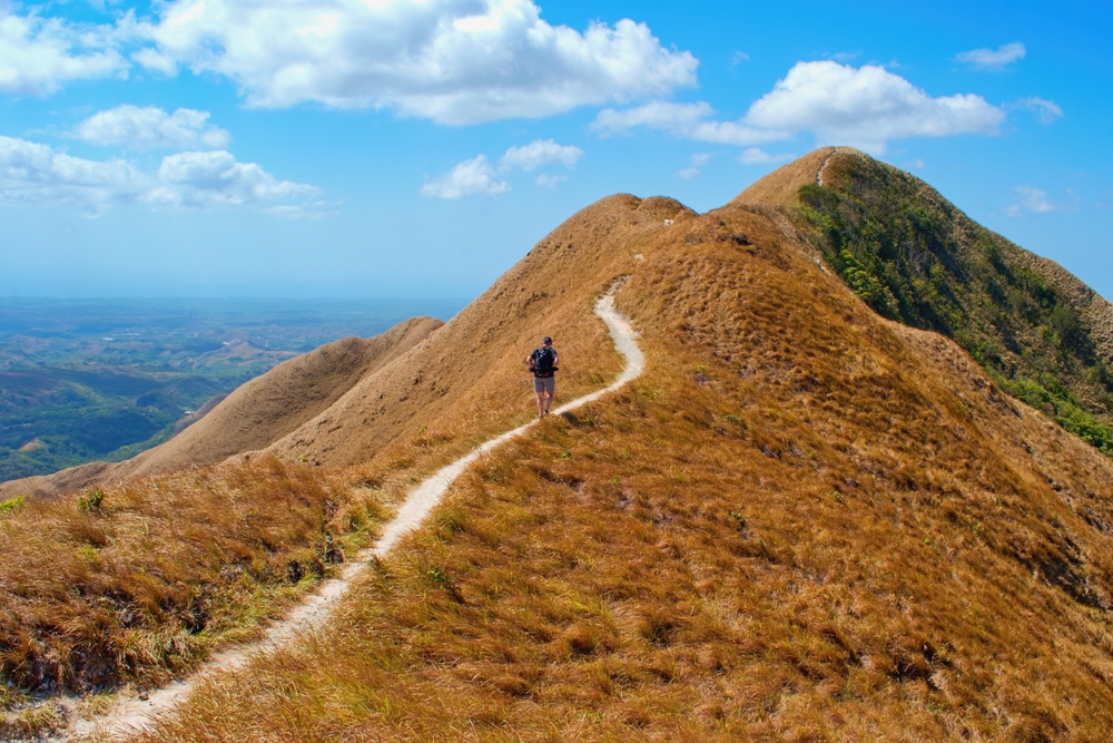Man hiker walking the path of inactive volcano