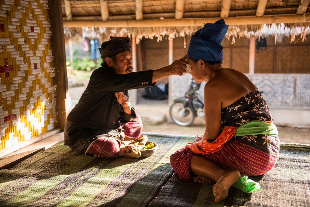 woman receive blessing from the village chief