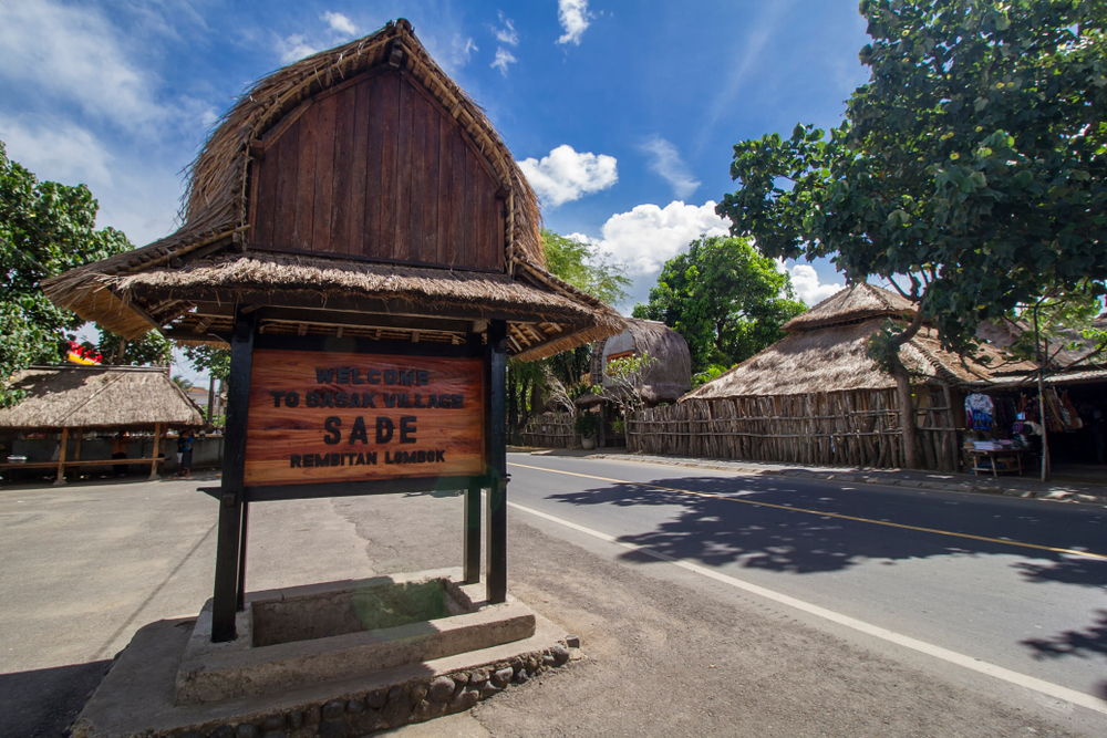 traditional sasak sade village sign beside the road