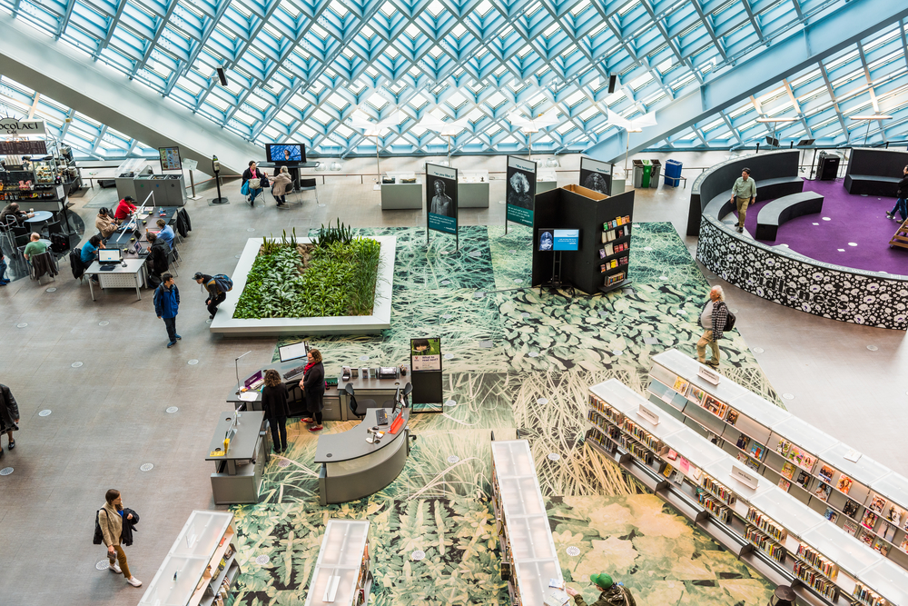 Aerial view of main floor of the Seattle public Central Library with modern glass architecture - 2016