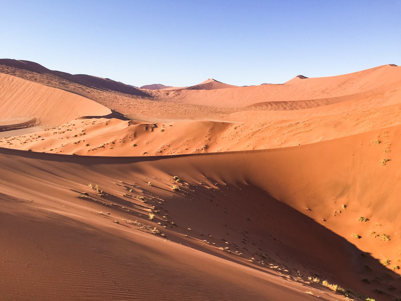 Brown Sand Dunes Under Blue Sky