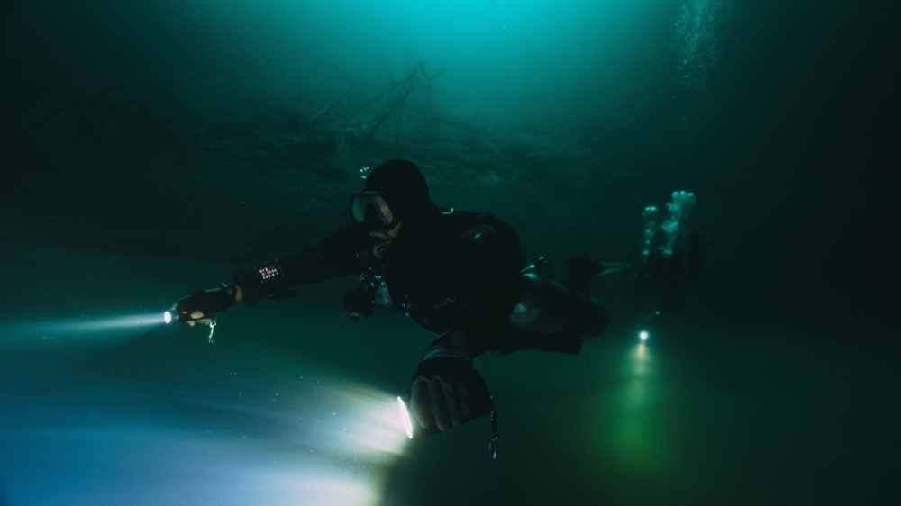 Diver holding two flashlights