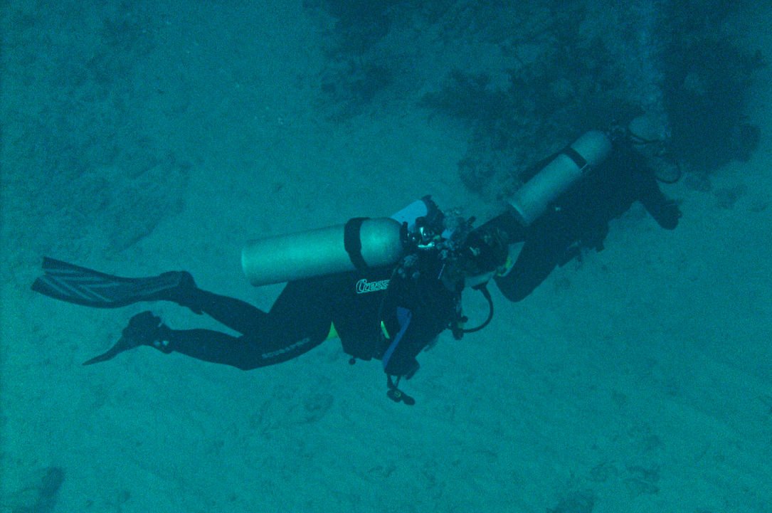 Close Up Photo of Scuba Divers under the sea.