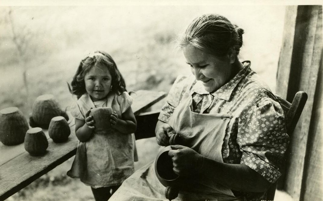 Grayscale Portrait Photo of of a woman and a young girl making clay pots