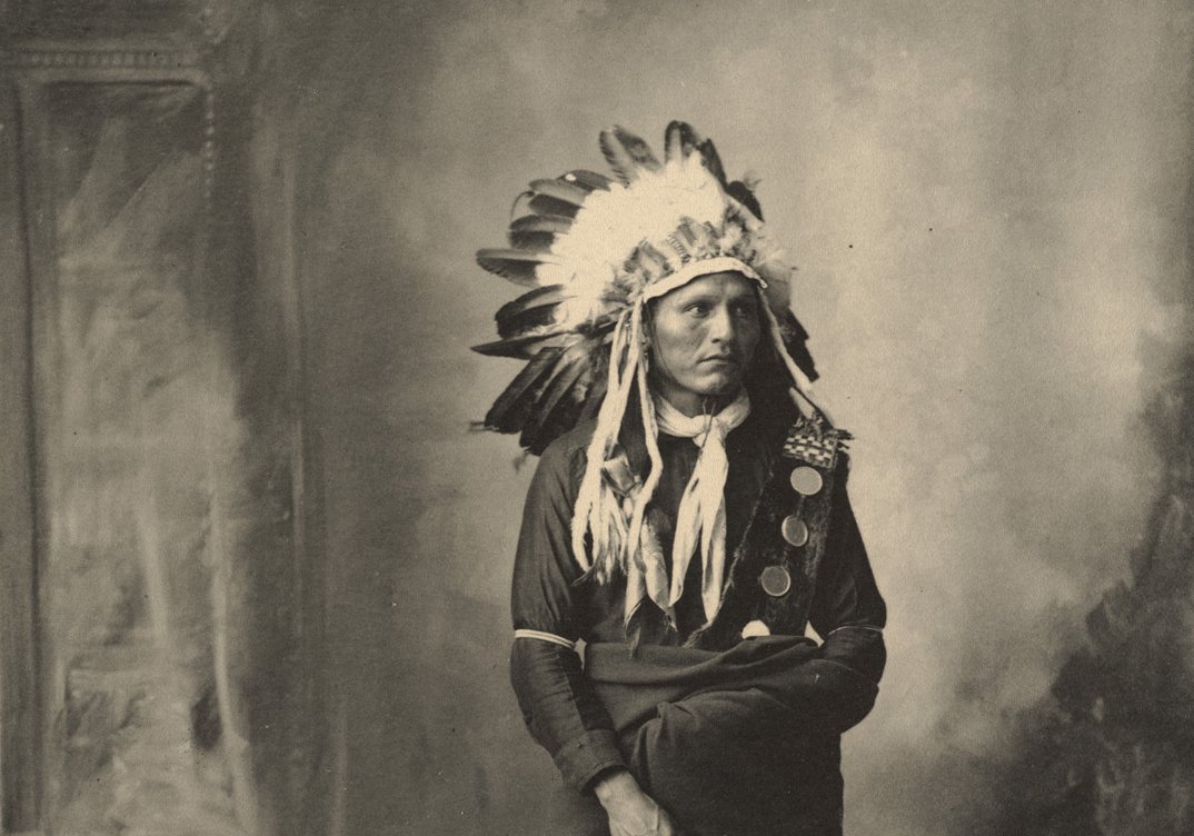 Grayscale Portrait Photo of Native American man in traditional clothing