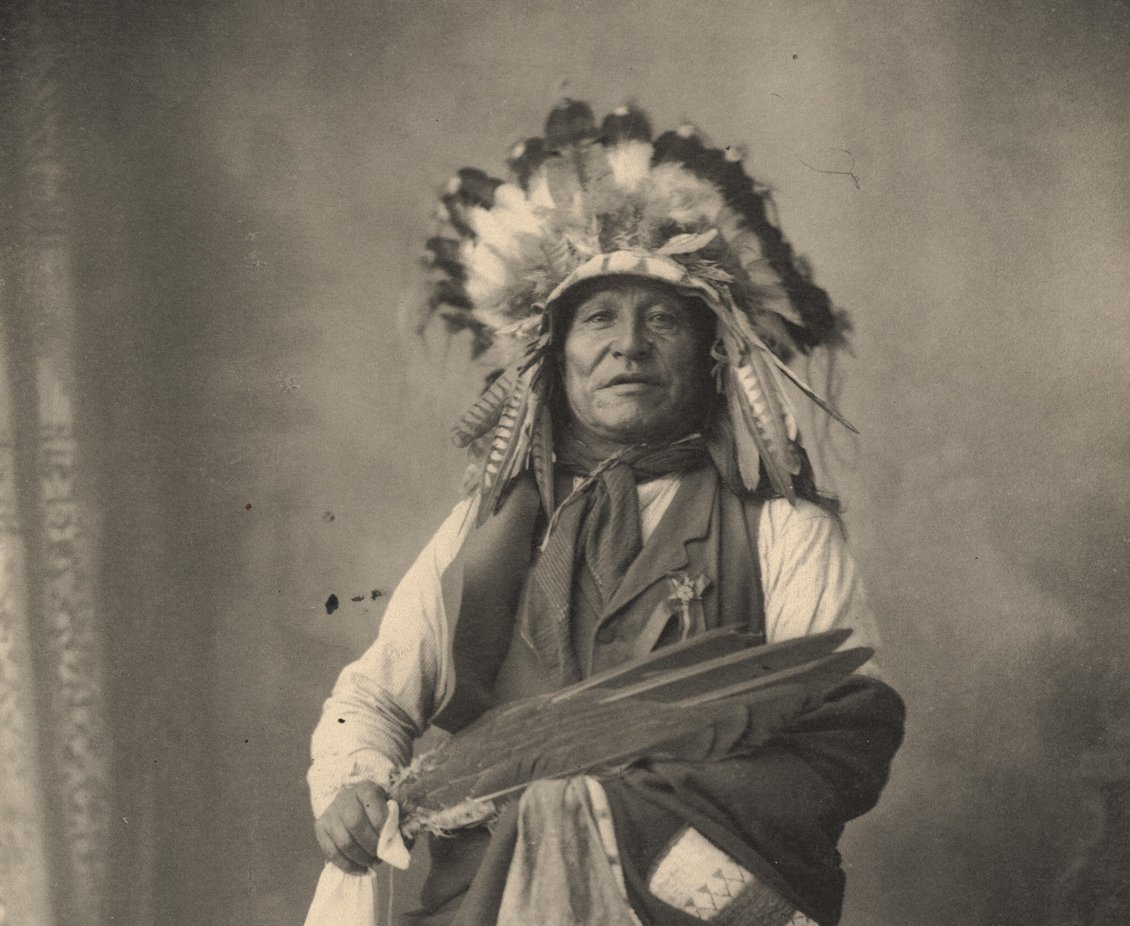 Grayscale Portrait Photo of Native American man in traditional clothing