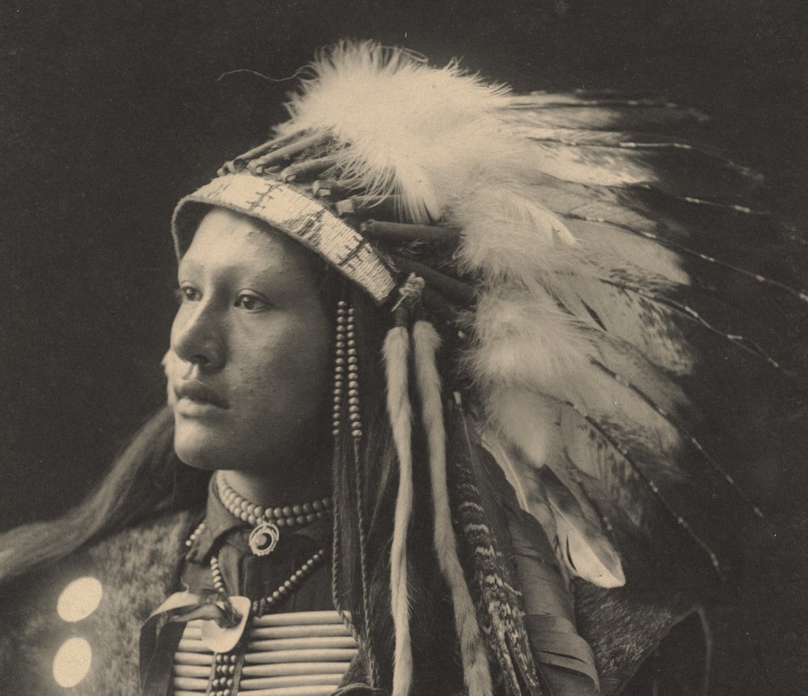 Grayscale Portrait Photo of Native American man in traditional clothing