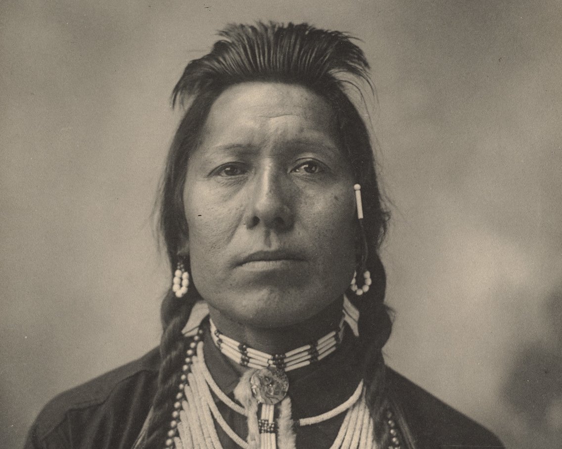 Grayscale Portrait Photo of Native American man and in traditional clothing