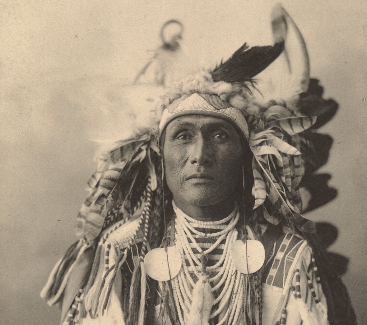 Grayscale Portrait Photo of Native American man in traditional clothing