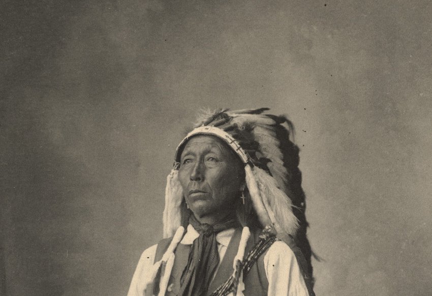Grayscale Portrait Photo of Native American man in traditional clothing