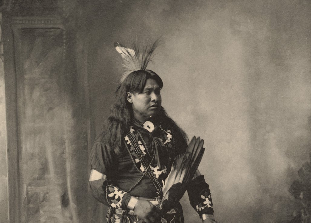 Grayscale Portrait Photo of Native American man in traditional clothing