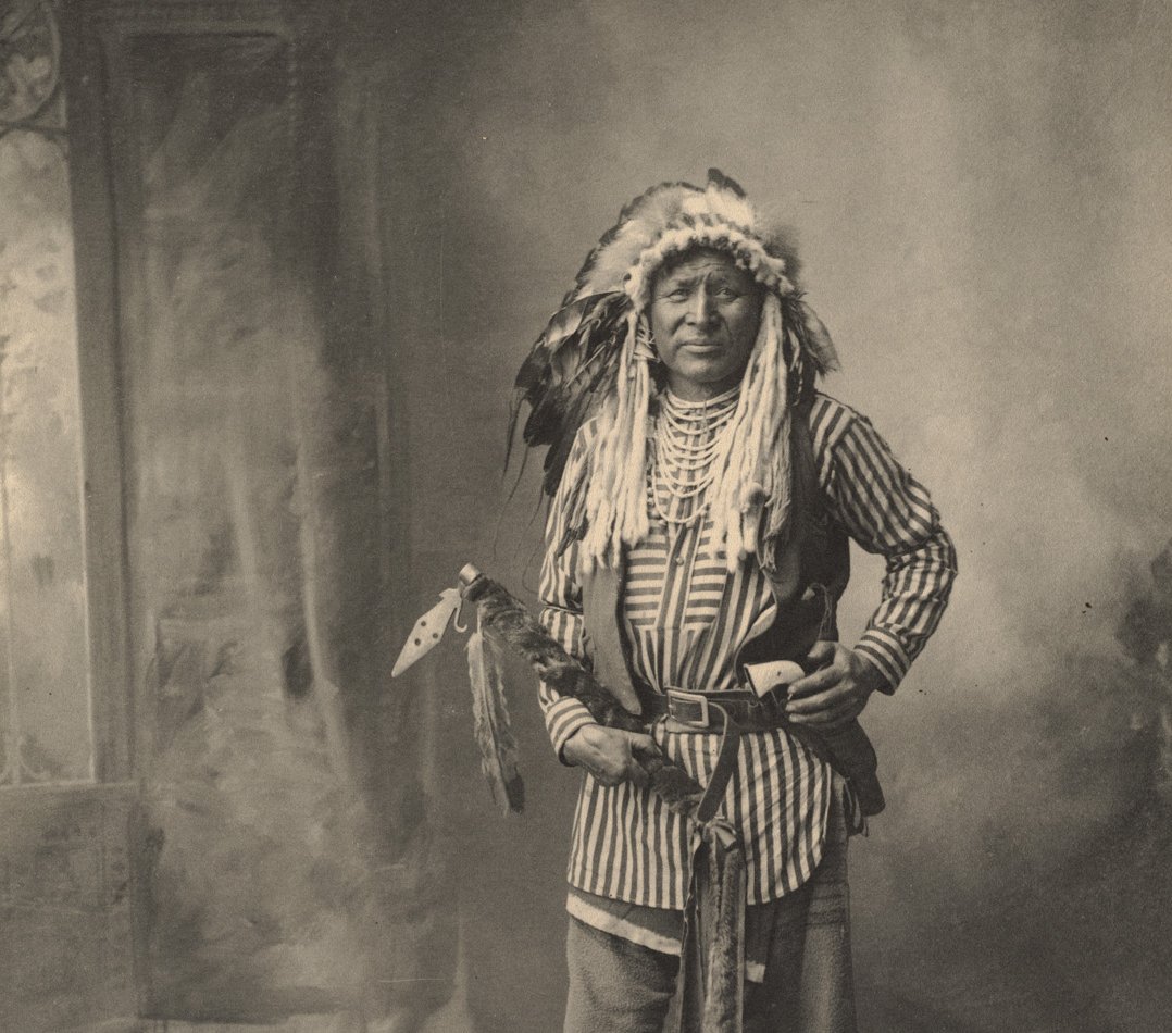 Grayscale Portrait Photo of Native American man in traditional clothing