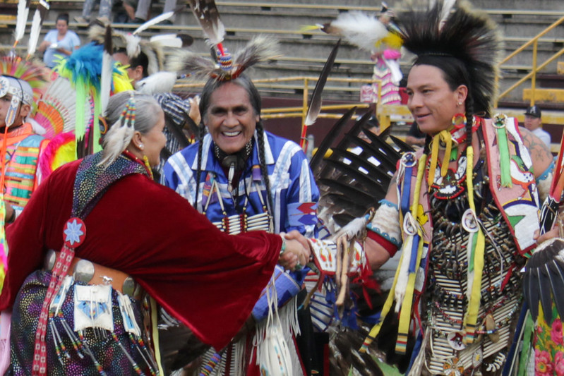 Portrait Photo of two native Americans friendly handshake.