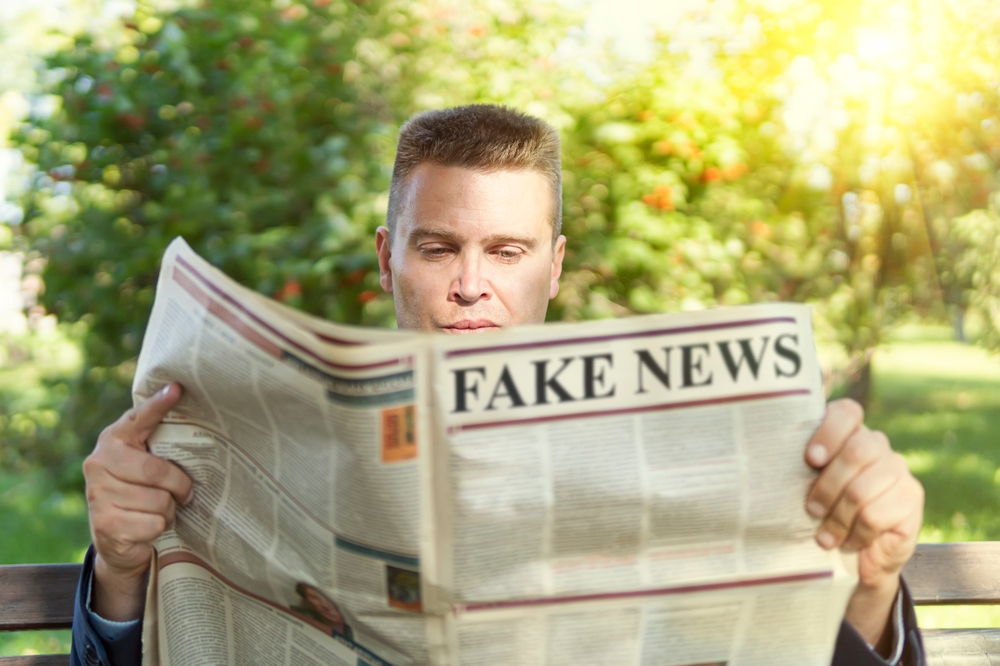 Man Reading Fake News