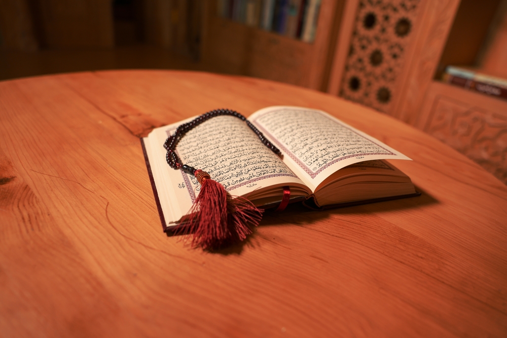 Holy Al Quran with written Arabic calligraphy