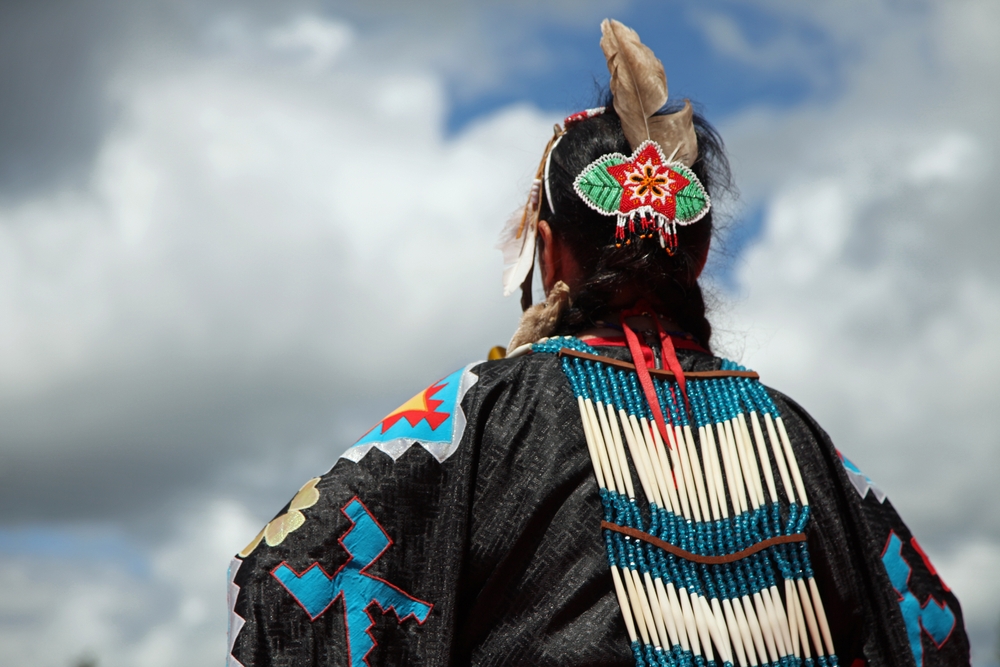 Close up Photo of Head of Native American woman in traditional costume