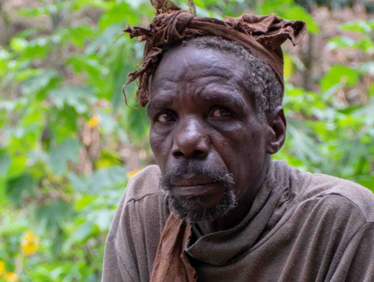 Leader of the Batwa group is telling stories about the life of the group.