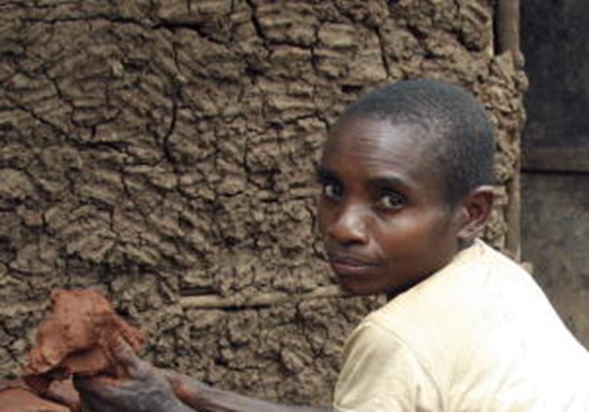 Batwa person Prepping Clay to Make Pots
