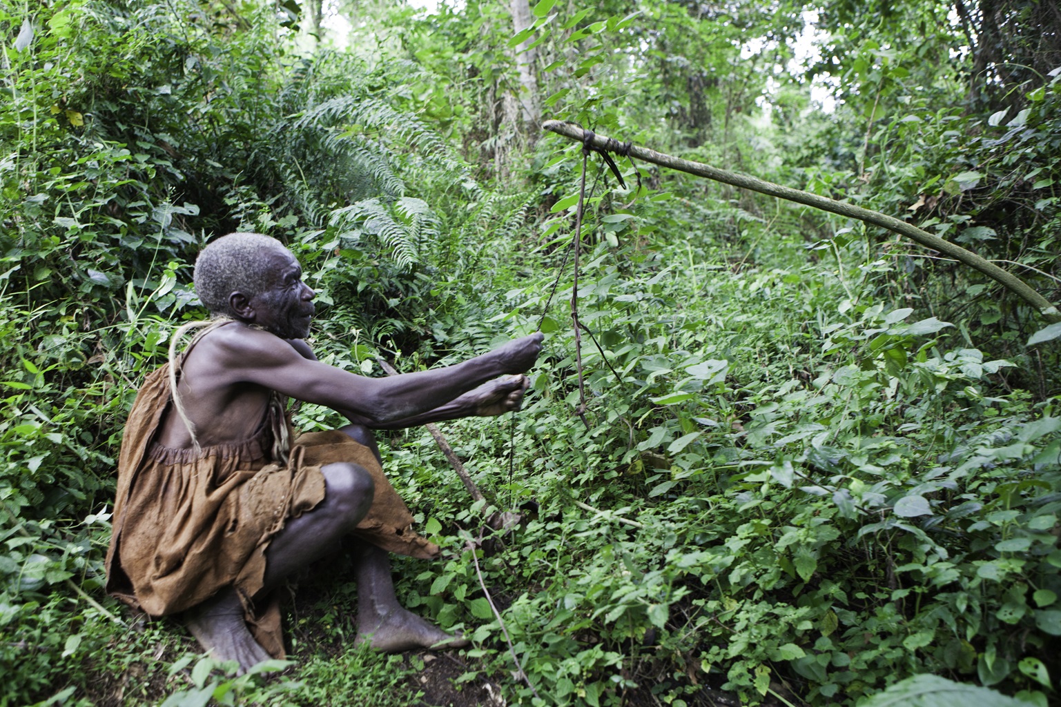 James demonstrates an animal snare trap in Bwindi Impenetrable Forest in Uganda.