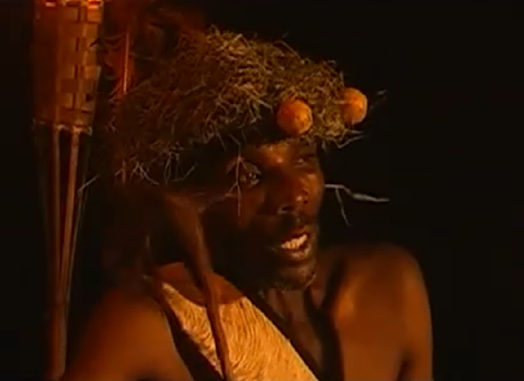 Screenshot of Batwa tribe man in night at forest - from The Batwa Legacy (2011)