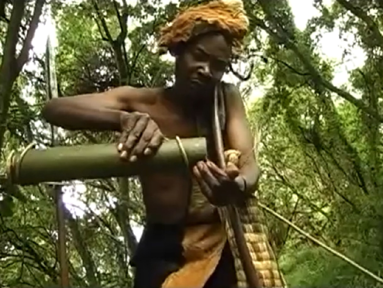 Screenshot of Batwa tribe man drinking water - from The Batwa Legacy (2011)