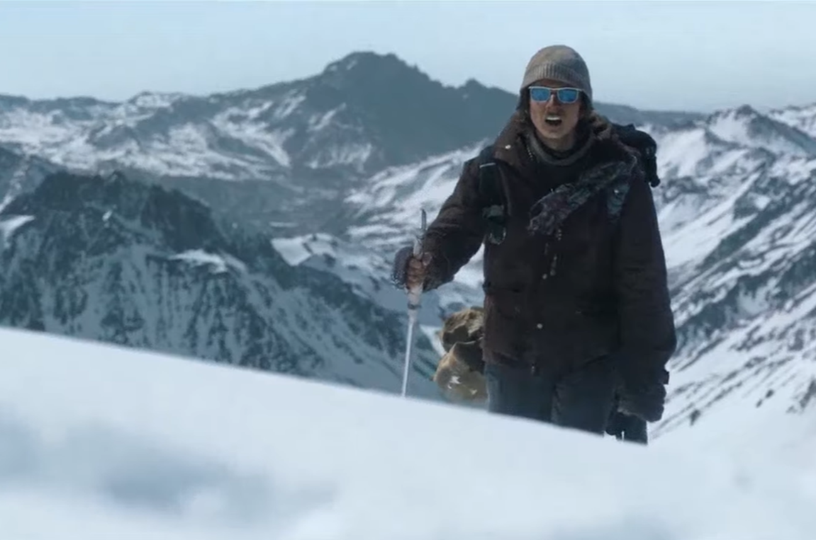 Screenshot of people walking on the snow - from Society of the Snow (2023)