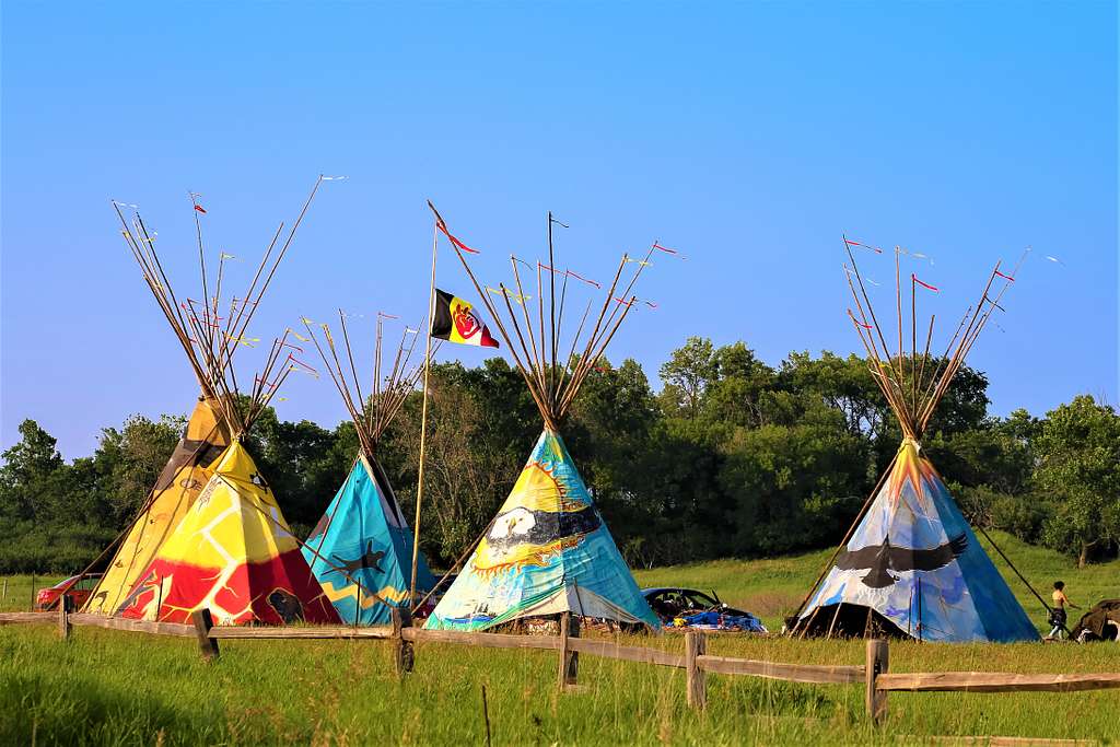 5 colorful tipis in a field