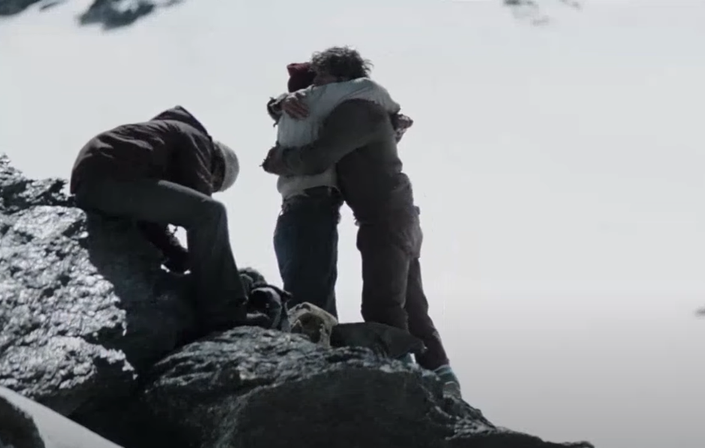 Screenshot of happy people walking on the snow - from Society of the Snow (2023)