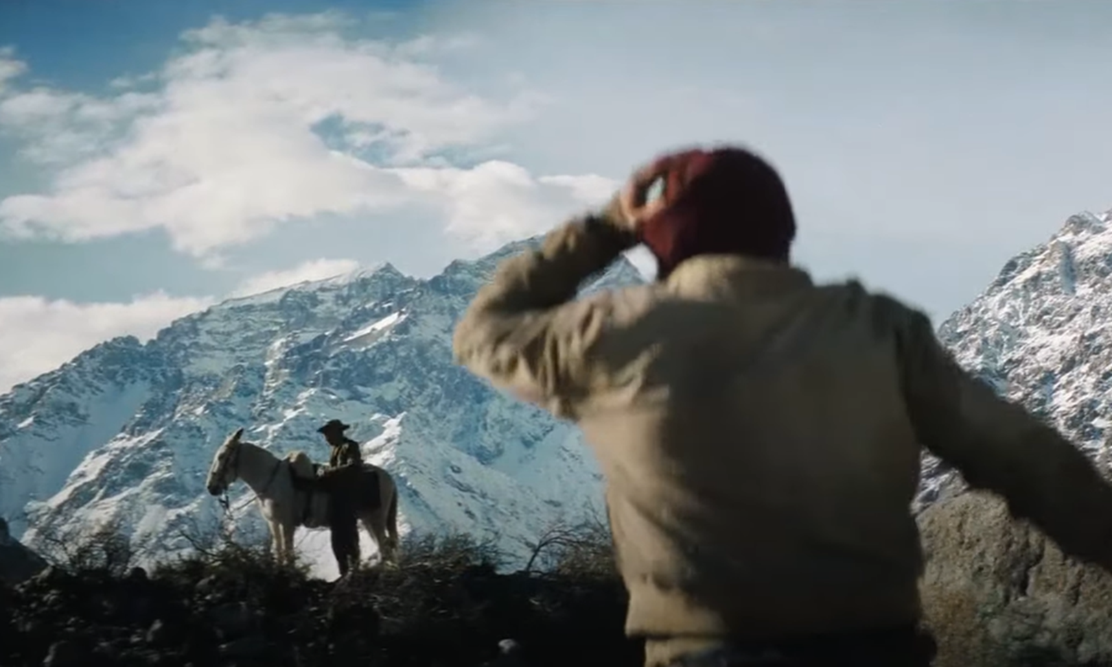 Screenshot of man looking at other man on the horse - from Society of the Snow (2023)