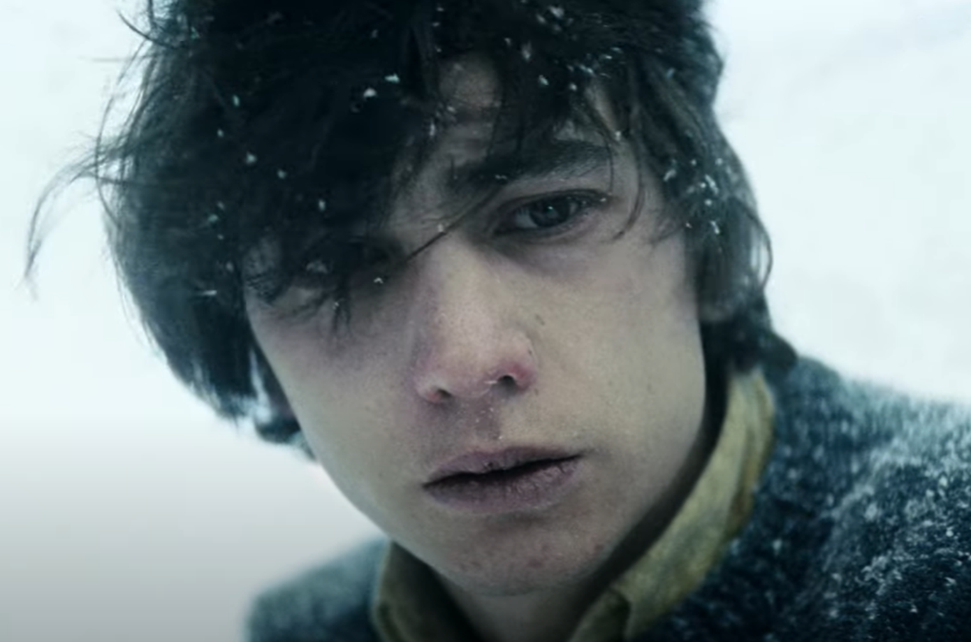 Screenshot of man looking upset outside - from Society of the Snow (2023)