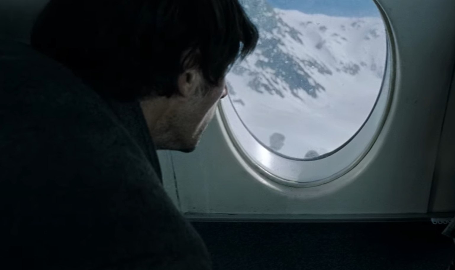 Screenshot of scared people on board on Flight 571 - from Society of the Snow (2023)