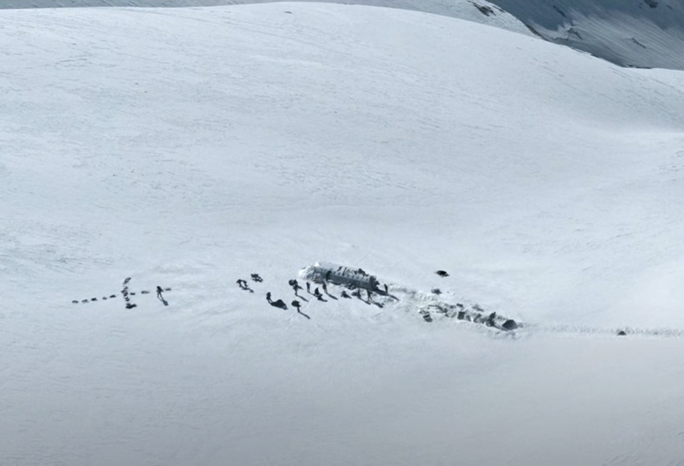 Screenshot of destroyed plane body in the snow - from Society of the Snow (2023)