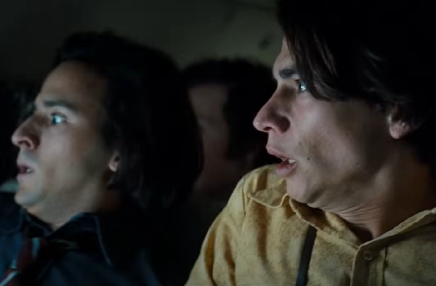 Screenshot of scared people on board on Flight 571 - from Society of the Snow (2023)