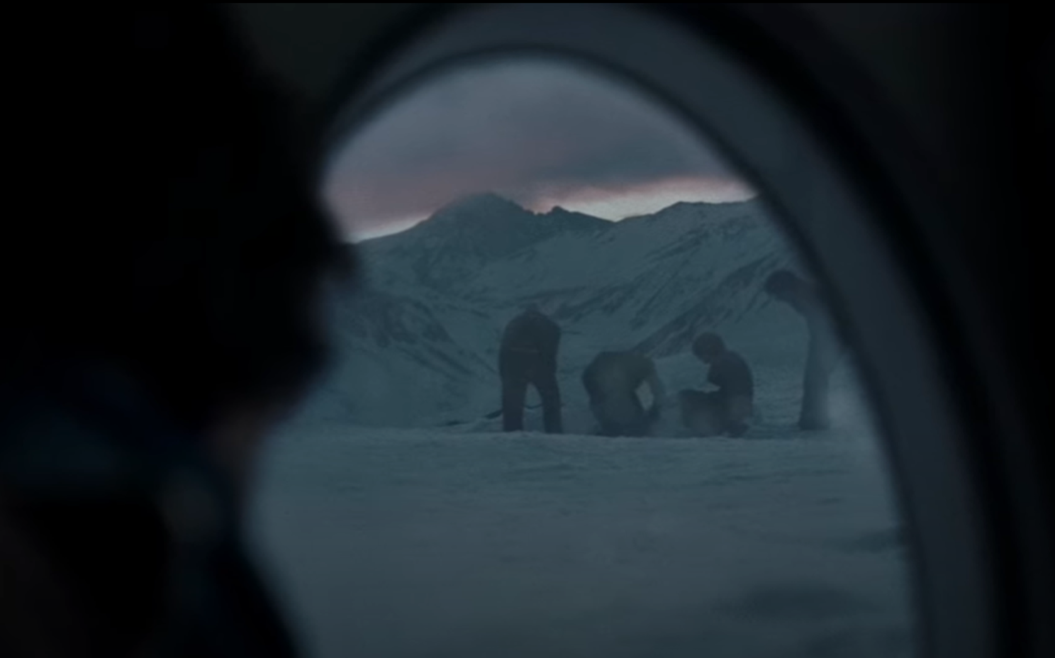 Screenshot of people digging in the snow outside - from Society of the Snow (2023)