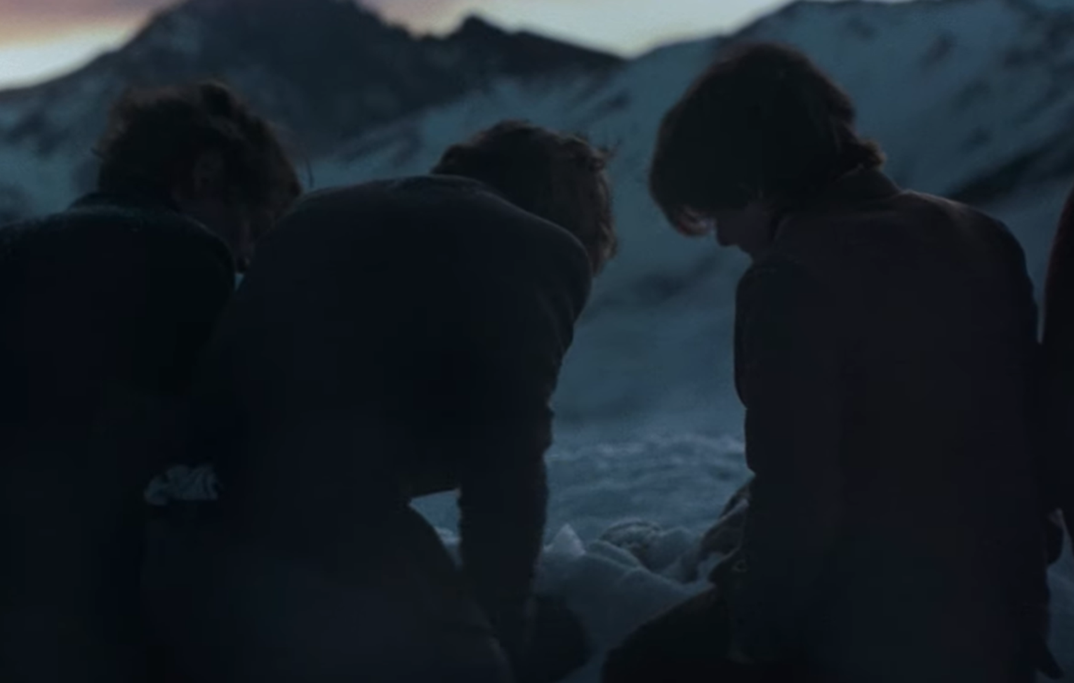 Screenshot of people digging in the snow outside - from Society of the Snow (2023)